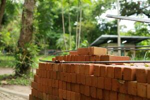 Pallet a red brick building material stack of new red bricks for construction. photo