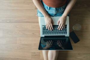 Woman Working by using laptop blank screen computer . Hands typing on a keyboard.technology e-commerce concept. photo