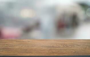 Empty wooden table in front of abstract blurred background of coffee shop . can be used for display or montage your products.Mock up for display of product photo