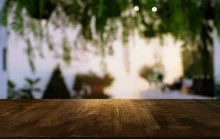 Empty wooden table in front of abstract blurred background of coffee shop . can be used for display or montage your products.Mock up for display of product. photo