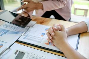 Team leader coach teach young workers explain on paper for business plan listen talkative coworker and discussing new project presentation Serious professional advisor consulting photo
