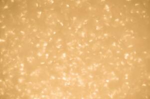 Gold glitters background. shimmering blur spot lights Bokeh Shiny gold light background. photo