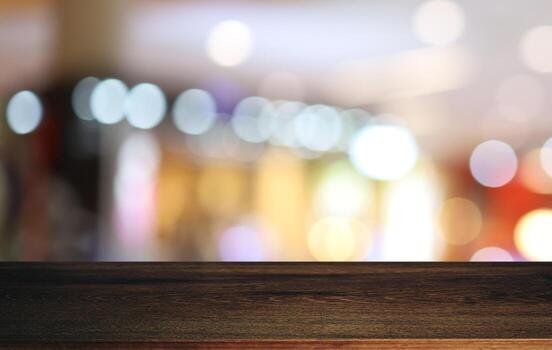 Empty wooden table in front of abstract blurred background of coffee shop . can be used for display or montage your products.Mock up for display of product photo