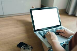 Woman Working by using laptop blank screen computer . Hands typing on a keyboard.technology e-commerce concept. photo