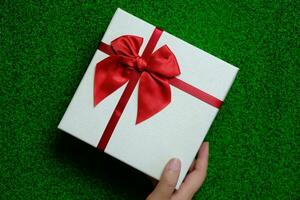 Happy New Year present. Gift box and red ribbon for Christmas. photo