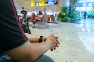 Man waiting for flight in airport departure area at airport waiting the flight photo
