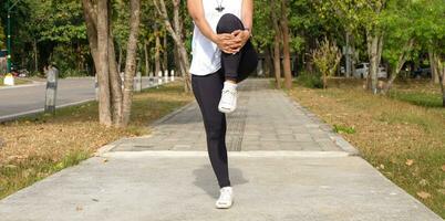 Young sporty woman workout before fitness training warming up in outdoors. photo