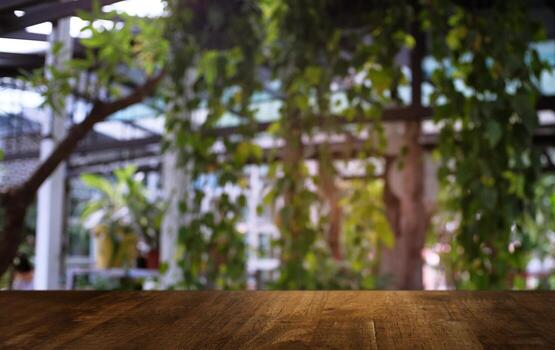 image of wooden table in front of abstract blurred background of outdoor garden lights. can be used for display or montage your products.Mock up for display of product. photo