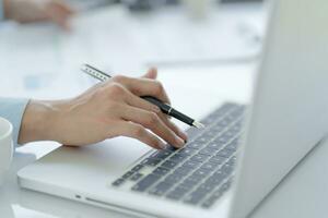 Business man working using laptop computer Hands typing keyboard. Professional investor working start up project. business planning in office. Technology business Concept photo