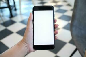 Close up of women's hands holding cell telephone blank copy space screen. smart phone with technology concept photo