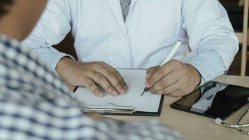 Doctor healthcare. Professional medical doctor in white uniform gown coat interview consulting patient reassuring his male patient helping hand photo