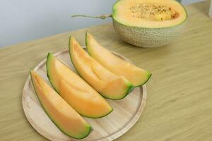 Fruits for healthcare Green Melon wooden table honey melon or cantaloupe photo