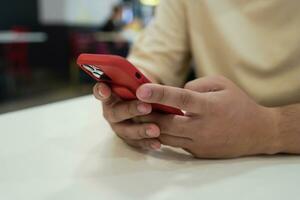 Relaxed young asian man using smart phone  spending time checking news social media. photo