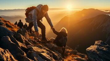 Helping each other, friend giving a helping hand while climbing up on the mountain rock. adventure travel concept of friendship support trust, teamwork success. photo