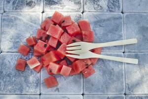 a fork and knife sitting on a pile of watermelon photo