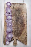 a cutting board with sliced red onions on it photo