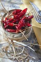 a silver container with dried red peppers photo