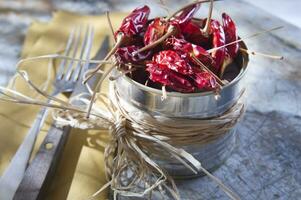 a silver container with dried red peppers photo