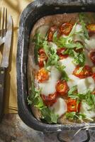 Pizza with tomato and arugula photo