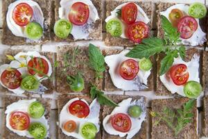 Slice of whole wheat bread and cherry tomatoes photo