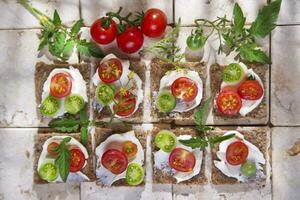 Slice of whole wheat bread and cherry tomatoes photo