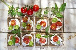 Slice of whole wheat bread and cherry tomatoes photo