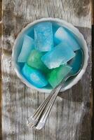 Bowl of colored ice-cubes photo
