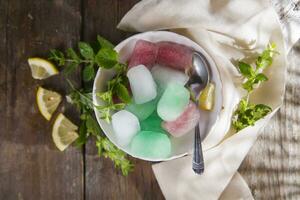 Bowl of colored ice-cubes photo