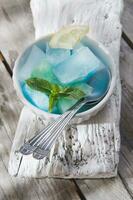 Bowl of colored ice-cubes photo