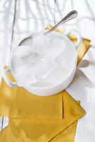 ice cubes in a bowl with a leaf on top photo