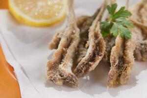 a plate of fish with a fork and knife on it photo