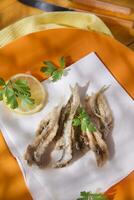 a plate of fish with a fork and knife on it photo