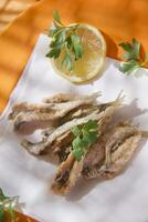 a plate of fish with a fork and knife on it photo