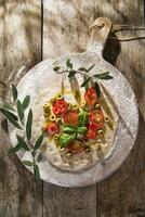 Raw pizza with tomato and olives photo