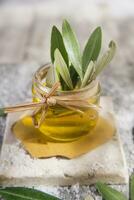 Small glass jar containing olive oil photo