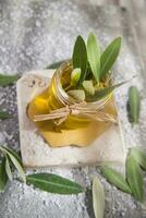 Small glass jar containing olive oil photo