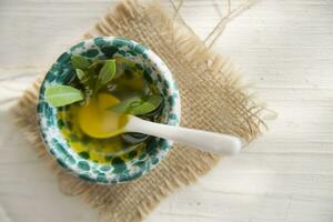 Small container with extra virgin olive oil photo