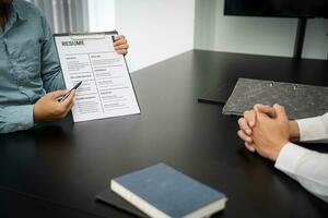 Examiner reading a resume during job interview at office Business and human resources concept. photo