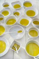 Small containers with extra virgin olive oil photo