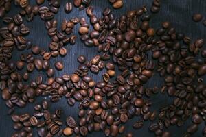 coffee beans are scattered on a table photo