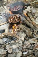 a pan of food cooking on a fire photo