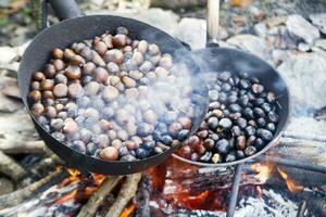 a pan of food cooking on a fire photo