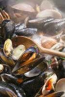a bowl of mussels with lemon and parsley photo