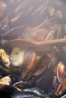 a bowl of mussels with lemon and parsley photo