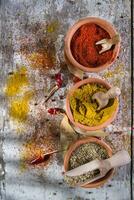 a wooden spoon with spices and other ingredients photo