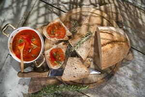 a bowl of soup with bread and a spoon photo