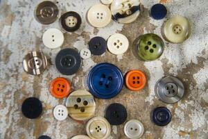 a collection of buttons on a table photo