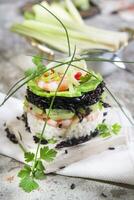 Tower of black and white rice with shrimp and zucchini photo