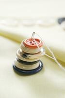 a pile of buttons on a white table photo