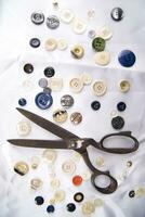 a pile of buttons on a white table photo